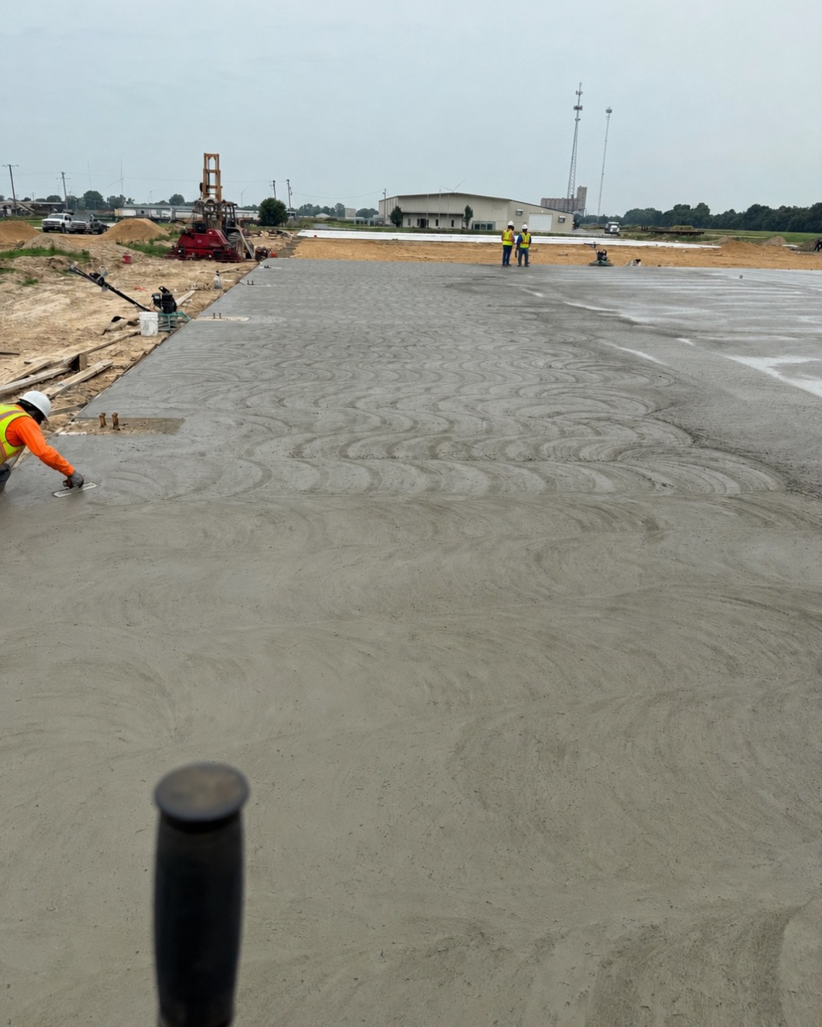 Crew hand-finishing a freshly poured warehouse slab at the Matthew's Farm Warehouse project in Wynne, AR